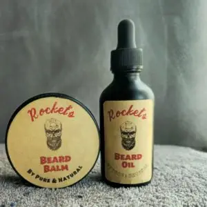 A bottle of beard oil and a round container