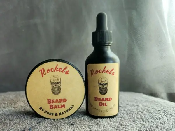 A bottle of beard oil and a round container