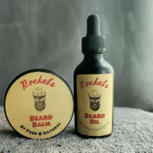 A bottle of beard oil and a round container