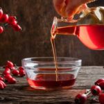 Pouring rose hip seed oil into a bowl -