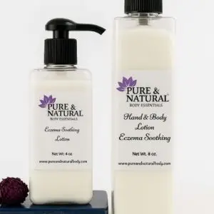 Pure & Natural Body Essentials Eczema Soothing Lotion – 4 oz and 8 oz bottles with pump tops, displayed on a stone with dried flowers.