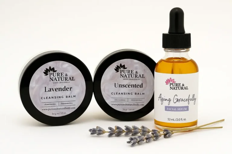 Pure & Natural Body Essentials skincare products — Lavender Cleansing Balm, Unscented Cleansing Balm, and Aging Gracefully Facial Serum — arranged on a white background with lavender sprigs, showcasing clean, Michigan-made, plant-based skincare.